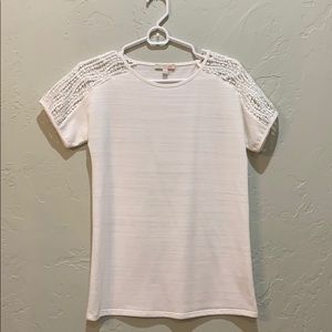 Plain white top with crochet on the shoulder area